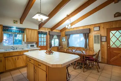 a kitchen with a table and a dining room at Yosemite Retreat in the Meadows in Wawona