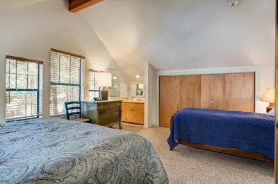 a bedroom with a bed and a desk and a kitchen at Wawona Retreat in Wawona