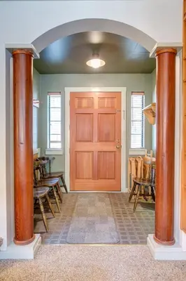 a room with a wooden door and some chairs at Wawona Retreat in Wawona
