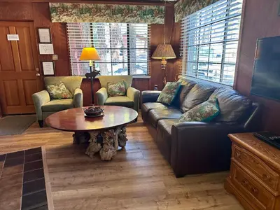 a living room with a couch and a table at Heart of the Meadow in Wawona