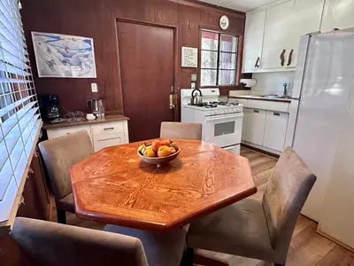 a kitchen with a wooden table with a bowl of fruit on it at Heart of the Meadow in Wawona