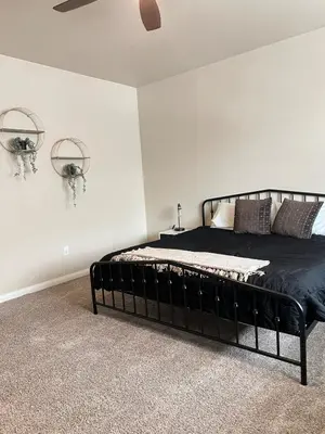 a bedroom with a black bed in a room at 30Min To SouthTahoe 3BD Parking in Carson City