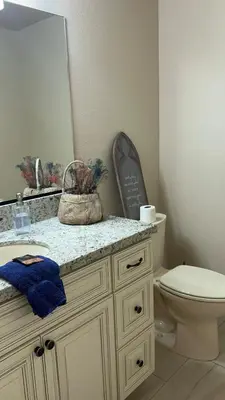a bathroom with a toilet and a sink and a mirror at 30Min To SouthTahoe 3BD Parking in Carson City