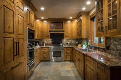 a kitchen with wooden cabinets and stainless steel appliances at Rustic Retreat in Wawona