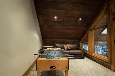 a ping pong table in the middle of a room at Rustic Retreat in Wawona