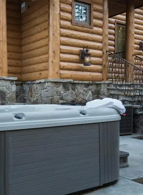 a bath tub sitting in front of a wooden wall at Rustic Retreat in Wawona