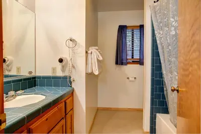 a bathroom with a sink and a shower at Cecil's Cabin in Wawona