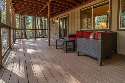 a screened porch with a couch and a table at We-Dunn-It in Wawona