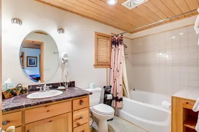 a bathroom with a sink and a tub and a toilet at River Refuge in Wawona