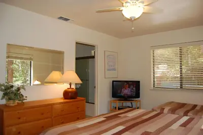 a bedroom with a bed and a television in it at Big Cedar in Wawona