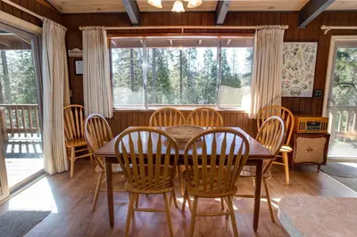 a dining room with a wooden table and chairs at Bird's Eye View in Yosemite West