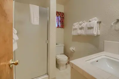a white bathroom with a toilet and a sink at Villarreal Retreat in Wawona