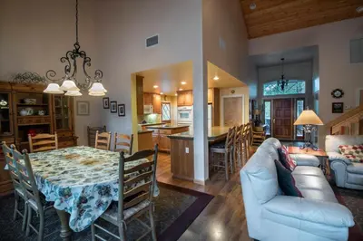 a kitchen and living room with a table and a couch at The Terry Cabin in Wawona