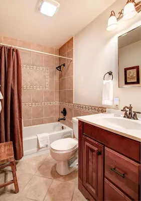 a bathroom with a sink and a toilet and a tub at Big Pine Lodge in Wawona