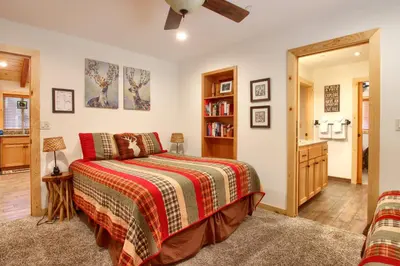 a bedroom with a bed and a book shelf at Larkspur Lair in Wawona