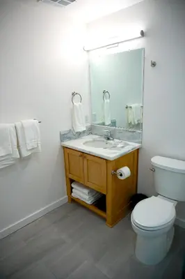 a bathroom with a sink and a toilet and a mirror at The Palisades Lodge of Big Pine in Big Pine