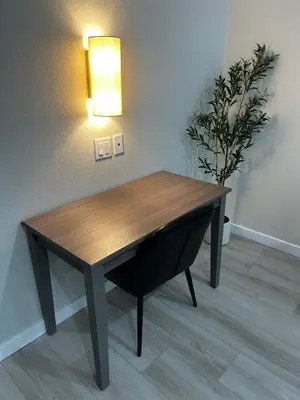 a wooden table in a room with a potted plant at The Palisades Lodge of Big Pine in Big Pine