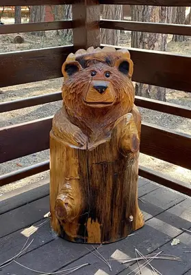 a wooden carving of a bear sitting on a stump at Cutter's Edge in Wawona