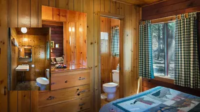 a wooden bathroom with a toilet and a sink at Lockwood Lodge in Wawona