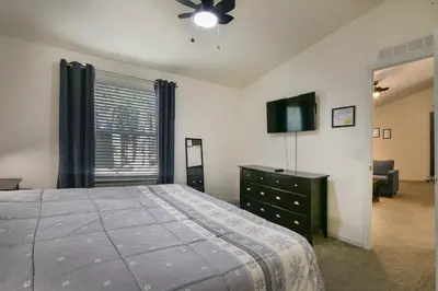 a bedroom with a bed and a tv and a dresser at Suter's Forte in Wawona
