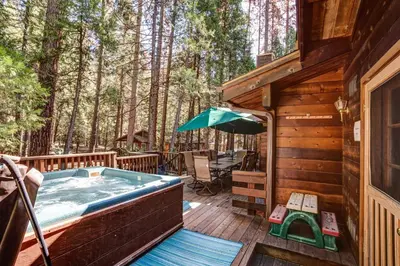 a hot tub on the deck of a cabin at Cedar Chalet in Wawona