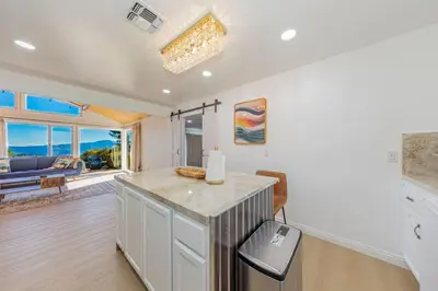 a kitchen with a counter and a living room at Hillside Sky Ranch Retreat 12 miles from Yosemite in Oakhurst
