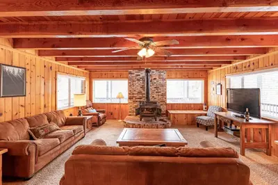 a living room with couches and a ceiling fan at Grant's Camp in Wawona