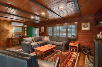a living room with two couches and a table at The Overlook in Wawona