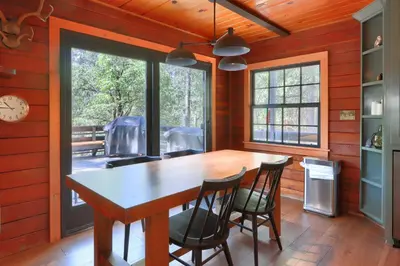 a dining room with a wooden table and chairs at The Overlook in Wawona