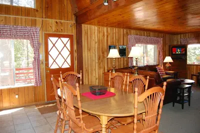 a dining room with a wooden table and chairs at Manzanita Lodge in Wawona