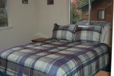 a bed in a room with a window at Altitude Adjustment in Wawona