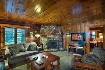 a living room with a couch and a fireplace at Sugar Pine Suite in Wawona