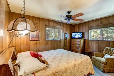 a bedroom with a bed and a ceiling fan at Mountain Memory in Wawona