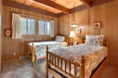 a bedroom with two beds and a window at Spindler's Chalet in Wawona