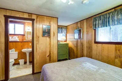 a bedroom with a bed and a sink and a toilet at Soots-Me in Wawona