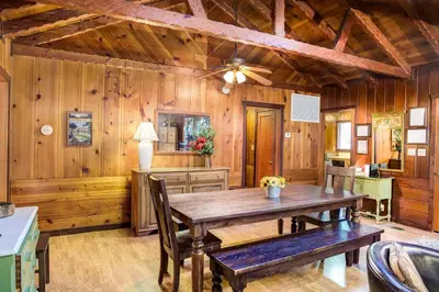 a dining room with a wooden table and chairs at Soots-Me in Wawona