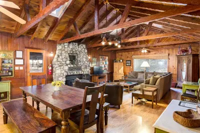 a dining room and living room with a wooden ceiling at Soots-Me in Wawona