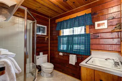 a bathroom with a toilet and a sink and a shower at Mia Mora in Wawona