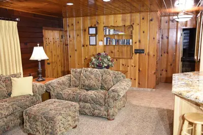 a living room with a couch and a chair at Tuolumne Meadow in Wawona