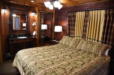 a bedroom with a bed and a sink and a mirror at Tuolumne Meadow in Wawona