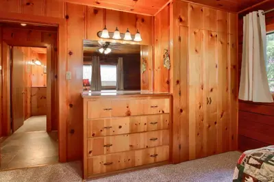 a room with wood paneled walls and a dresser at Deer Creek in Wawona