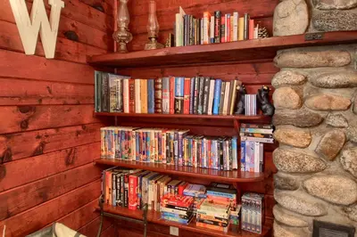 a book shelf filled with lots of books at The Williams Cabin in Wawona