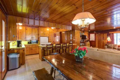 a kitchen and dining room with a wooden ceiling at Hansen Cabin in Wawona