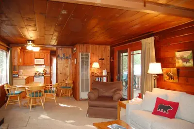 a living room with a couch and a table at Squirrel's Nest in Wawona