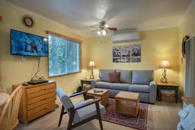 a living room with a couch and a table at Sparrow's Nest in Wawona