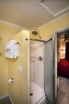 a bathroom with a shower with a glass door at Sparrow's Nest in Wawona