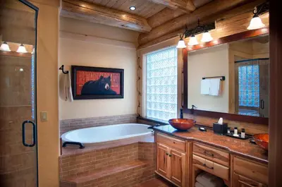 a bathroom with a tub and a large mirror at El Capitan in Wawona