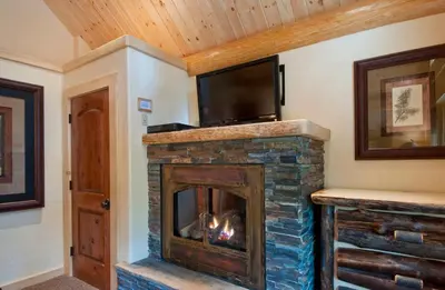 a fireplace with a television on top of it at El Capitan in Wawona
