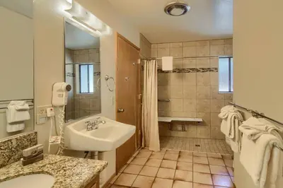 a white bathroom with a sink and a shower at Bordentown West in Wawona