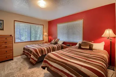 two beds in a room with red walls at Bordentown West in Wawona